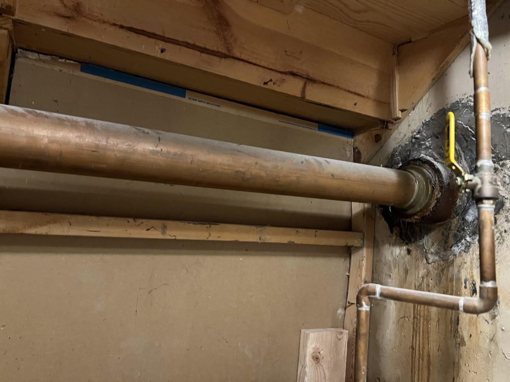 Plumbing With A Capitol M And Inverted Triangle Over It