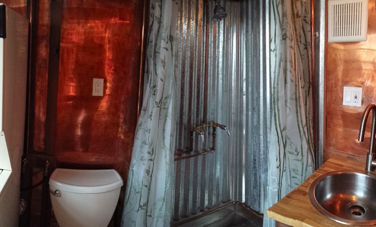 Corrugated Metal Shower Stall With Exposed Copper Plumbing